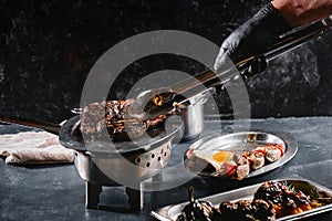 Juicy beef steak flips in a barbecue flame, life style, food photo, copy space