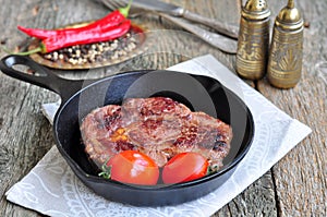 Juicy beef steak in a frying pan