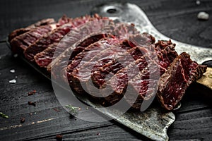 Juicy Beef steak over meat butcher knife. Food recipe background. Close up