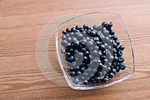 Juicy blueberry in glass plate