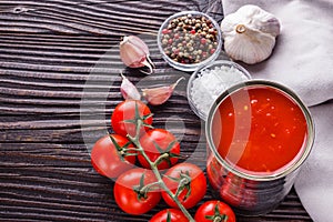 Juicy canned tomatoes on wooden rustic background