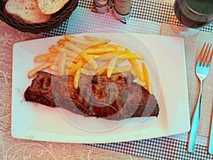 Juicy churrasco veal ribs with crispy french fries