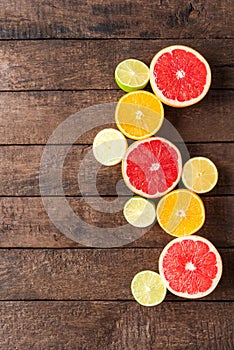 Juicy citruses on wooden background.