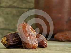 Juicy dates on a old wooden table. Copy space, selective focus