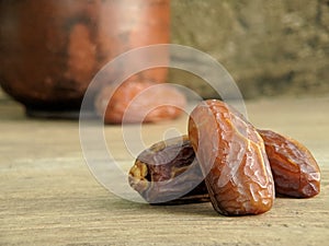 Juicy dates on a old wooden table. Copy space, selective focus