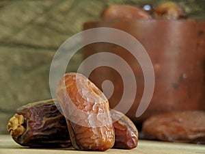 Juicy dates on a old wooden table. Copy space, selective focus