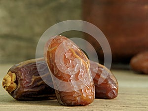 Juicy dates on a old wooden table. Copy space, selective focus