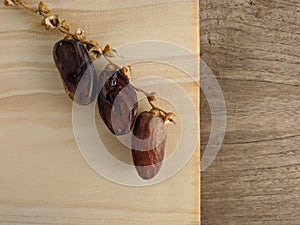 Juicy dates on a old wooden table. Copy space, selective focus