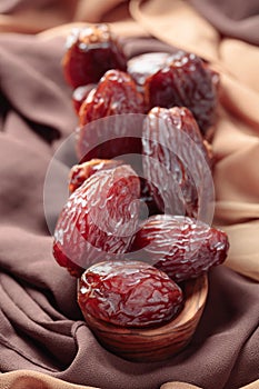 Juicy dates on the table with satin