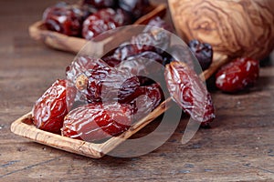 Juicy dates on wooden table .