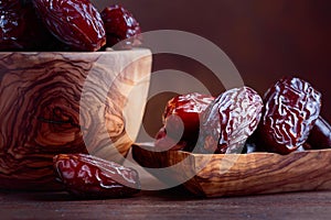 Juicy dates on wooden table .