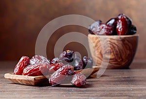 Juicy dates on wooden table .