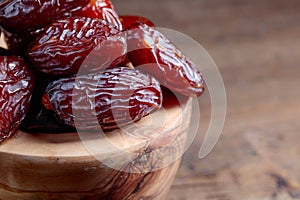 Juicy dates on wooden table .