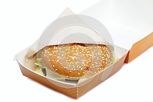 Juicy delicious burger in a box. Delicious fast food. Close-up. Isolated on a white background