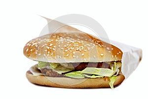 Juicy delicious burger in a box. Delicious fast food. Close-up. Isolated on a white background