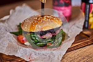 Juicy delicious burger on a wooden Board