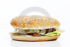 Juicy delicious hamburger. Delicious garbage popular food. Isolated on a white background. Close-up