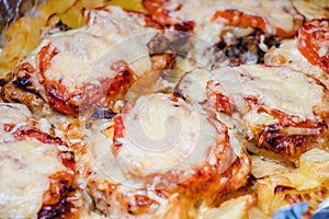 Juicy, fragrant baked meat with tomatoes, pepper, cheese, mayonnaise and spices