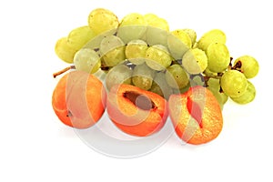 juicy fresh apricots and grapes on a white background photo