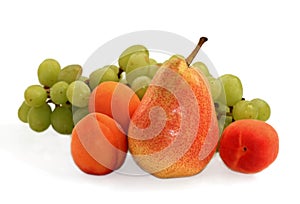 juicy fresh pears apricots and grapes on a white background photo