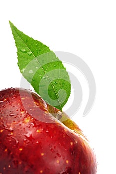 Juicy fresh red apple with green leaf isolated