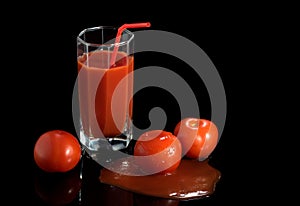Juicy fresh red tomatoes in juice on a black dark background