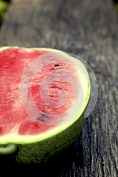 Juicy fresh red watermelon on the table. Watermelon sliced into pieces on a wooden texture background.