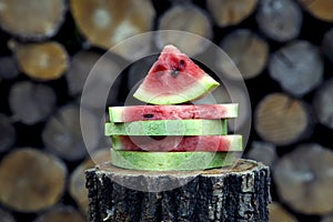 Juicy fresh red watermelon on the table. Watermelon sliced into pieces on a wooden texture background.