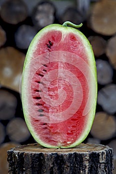 Juicy fresh red watermelon on the table. Watermelon sliced into pieces on a wooden texture background.