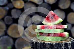 Juicy fresh red watermelon on the table. Watermelon sliced into pieces on a wooden texture background.