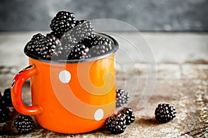 Juicy fresh ripe blackberry in vintage cup