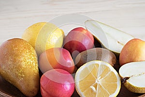 Juicy fruit close-up, healthy foods, diet ingredients, kiwi slices near lemon and juicy peaches