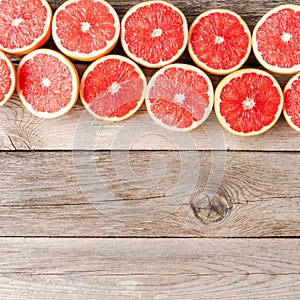 Juicy grapefruit halves on wooden table.