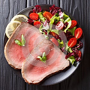 Juicy grilled beef steak with fresh vegetable salad close-up on