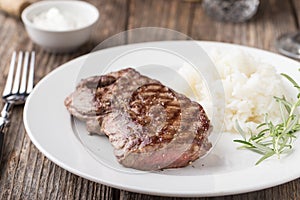 Grilled beef steak with rice and rosemary