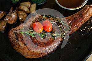 Juicy grilled pork chop with rosemary leaf, mushroom, garlic, to