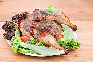 Juicy grilled roast chicken with herb, lettuce and tomato garnis