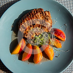 Juicy grilled turkey steak with caramelized peach.