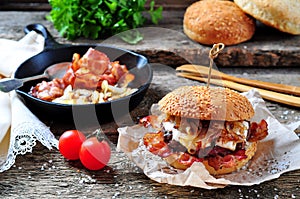 Juicy homemade double burger beef with fried onions on a wooden background