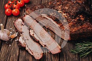 Juicy hunk of smoked meat on a wooden background. BBQ