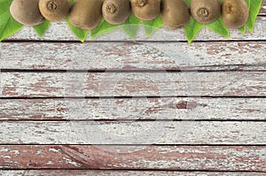Juicy kiwi fruit on wooden background.