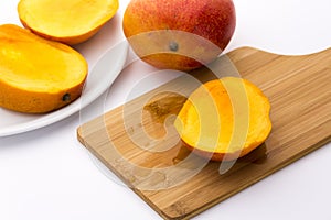 Juicy Mango Slice On A Wooden Cutting Board