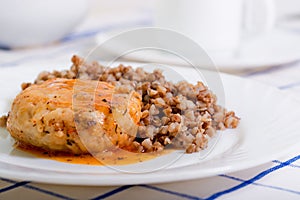 Juicy meat cutlet with tomato sauce with buckwheat