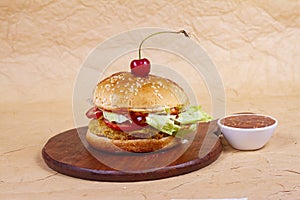 Juicy mexican burger, hamburger or cheeseburger with one chicken patties, with sauce. Concept of mexican fast food. Copy space