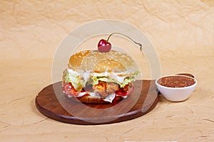 Juicy mini snack burger, hamburger or cheeseburger with one chicken patties, with sauce . Concept of American fast food. Copy