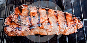 Juicy New York strip steak on a grill