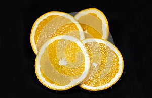 Juicy orange slieces on black background