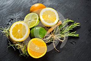 Juicy oranges and limes n black background