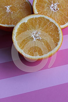 juicy oranges on a pink table, vitamins, citruses, textured table background, abstract background, nature, ripe bright oranges