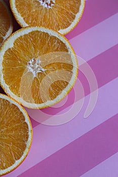 juicy oranges on a pink table, vitamins, citruses, textured table background, abstract background, nature, ripe bright oranges